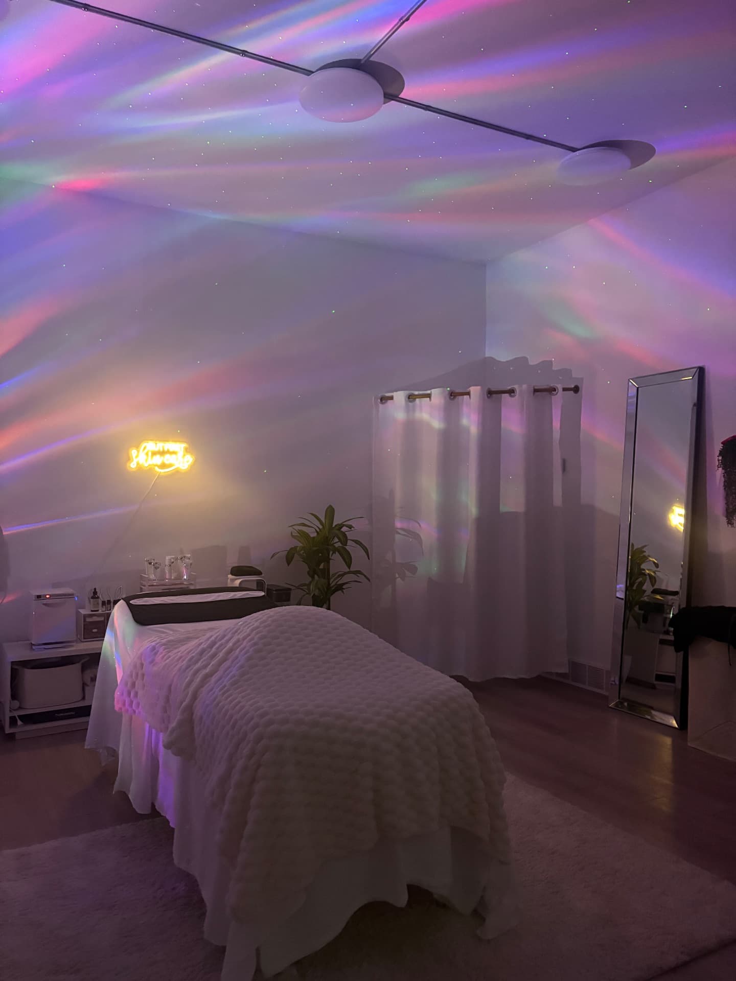 The Aurora Skin Co. treatment room lit by the aurora projector